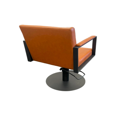 Orange salon chair with black frame on a white background