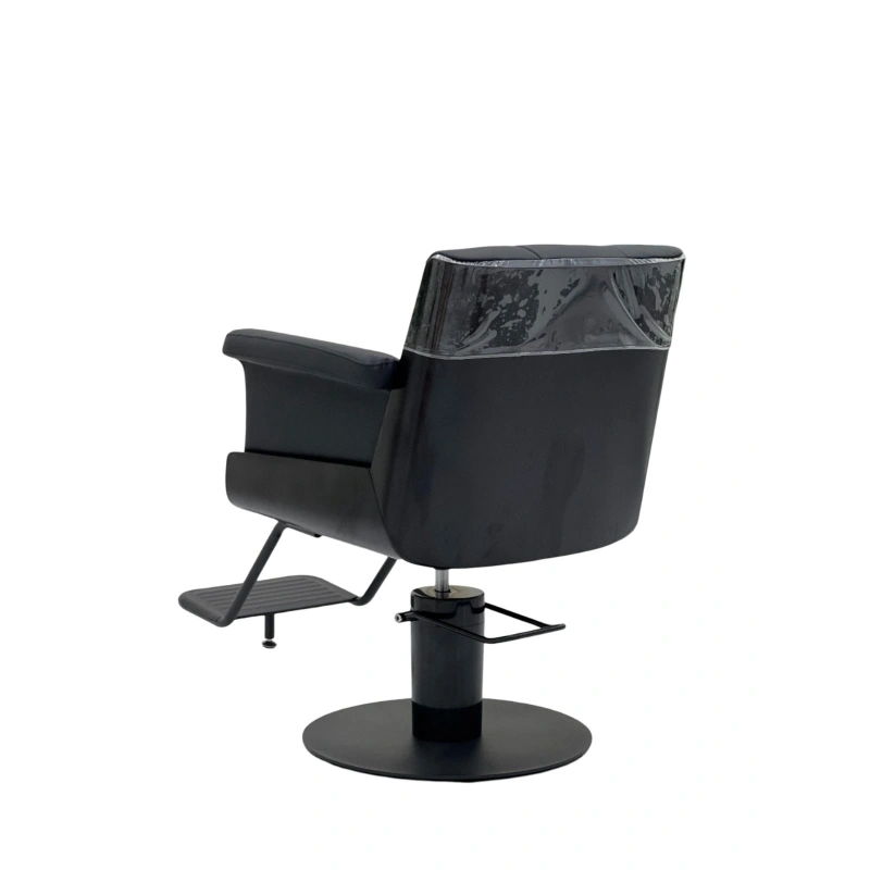 Black salon chair with a patterned headrest on a white background